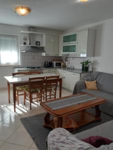 a kitchen and living room with a table and chairs at Apartment Ana in Poreč