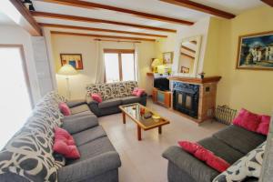 a living room with couches and a fire place at Finca Palacios - comfortable holiday accommodation in Benissa in Benissa