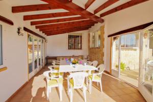 a dining room with a white table and chairs at Finca Palacios - comfortable holiday accommodation in Benissa in Benissa