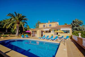 a villa with a swimming pool and a house at Finca Palacios - comfortable holiday accommodation in Benissa in Benissa