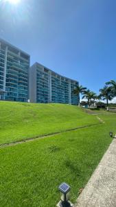 a building with a light in a field of grass at Apartamento en BalaBeach María Chiquita in front of the beach 2hab in Colón