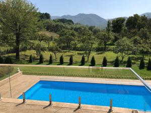 a swimming pool with a view of a field and trees at Villa Bergzicht in Vulcan