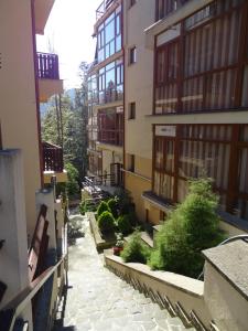 an alley between two buildings in a city at Alpin Residence in Sinaia