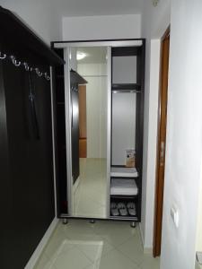 a bathroom with a mirror and a walk in closet at Alpin Residence in Sinaia +23 photos