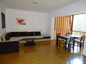a living room with a couch and a table at Alpin Residence in Sinaia