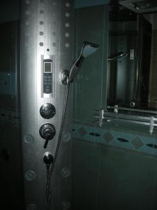 a shower in a bathroom with a shower head at Hotel Total in Pisogne