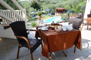 a table with chairs and a table cloth at Poggio Degli Olivi in Monsummano Terme