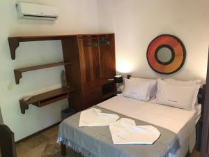 a bedroom with a bed with two towels on it at Casa Bouganville apartamento 4 in Jericoacoara +17 photos
