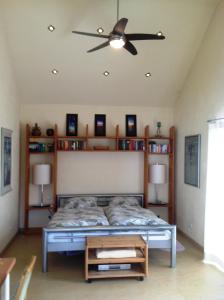 a bedroom with a bed and a ceiling fan at Ferienappartment Allendorf in Sundern