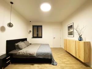 A bed or beds in a room at Apartmány Elli