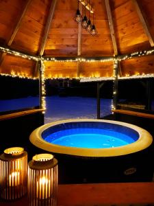 a large hot tub in a room with lights at Apartmány Elli in Mýto pod Ďumbierom