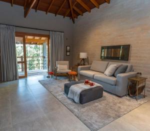 a living room with a couch and a table at Canto do Irere - Boutique Hotel in Atibaia
