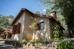 a house in the middle of a forest at Canto do Irere - Boutique Hotel in Atibaia