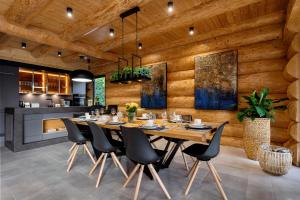 a dining room with a large wooden table and chairs at Międzybrodzie Bialskie Apartamenty Nowy Świat in Międzybrodzie Bialskie