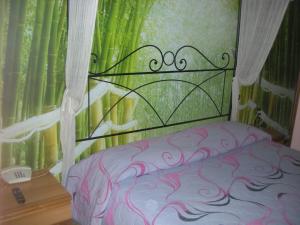 a bedroom with a bed with a iron head board at Hotel Total in Pisogne
