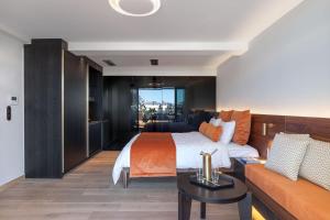 a hotel room with a bed and a couch at The Newel Acropolis in Athens