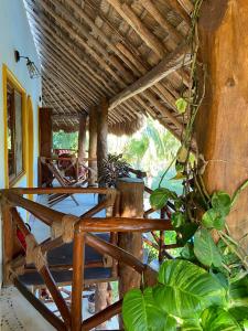 um quarto com mesa, cadeiras e plantas em Casa Hridaya Hotel Boutique em Ilha Holbox