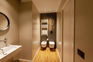 a bathroom with two toilets and a sink at Palazzo al Carmine in Monreale