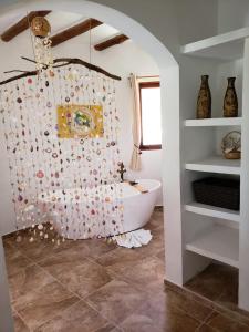 a bathroom with a white tub and a sink at Casa Hridaya Hotel Boutique in Holbox Island