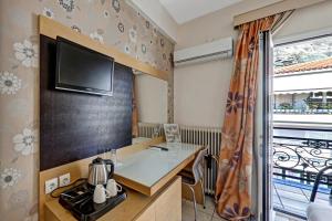 a hotel room with a desk and a tv at Hotel Rex in Kalabaka
