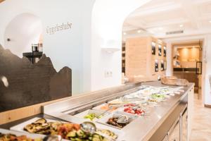 a buffet line with many different types of food at Boutique Hotel Eggele in San Candido