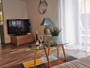 a living room with two glass tables and a tv at Carpe Diem - cote-montagnes in Oderen