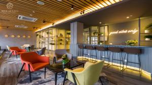 a lobby of a hotel with chairs and a bar at Ceylonz Suites Kuala Lumpur, Roam in Kuala Lumpur