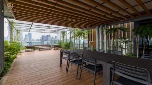 a balcony with a table and chairs on a building at Ceylonz Suites Kuala Lumpur, Roam in Kuala Lumpur