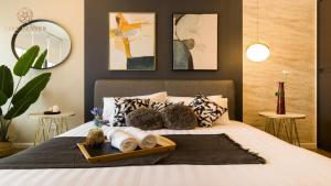 a bedroom with a bed with a tray of towels at Ceylonz Suites Kuala Lumpur, Roam in Kuala Lumpur +23 photos