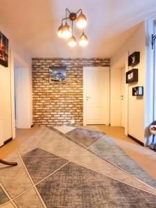 a room with a brick wall and a rug on the floor at Dream House in Buşteni