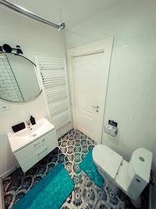 a bathroom with a toilet and a sink and a mirror at Dream House in Buşteni +29 photos