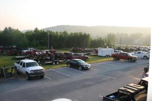 a parking lot filled with lots of cars and trucks at Grand Vista Hotel in Huntsville