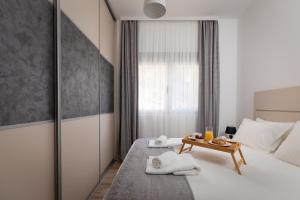 a bedroom with a bed and a table with towels at Bonintro Lux Apartment in Kotor