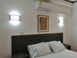 Postel nebo postele na pokoji v ubytování Hotel 42 Avenida
