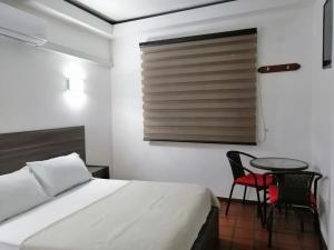 Postel nebo postele na pokoji v ubytování Hotel 42 Avenida