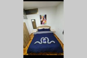a bedroom with a bed with a blue comforter at comfy snow night 1 in Majdal Shams