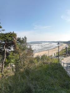 a view of a beach with a road and the ocean at Sellin - Seedorf Am Neuensiener See Apartment 08 in Seedorf