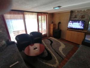a living room with a couch and a tv at Jajce,Plivsko jezero in Jajce