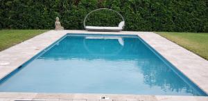a swimming pool with a chair in a yard at Casa Catalina in Homestead