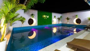 a swimming pool with blue lights in a hotel at BVM HOTEL in Ninh Binh