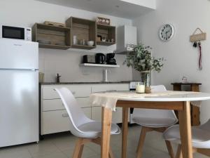 a kitchen with a table and chairs and a refrigerator at Andoli 1 in Santa Rosa