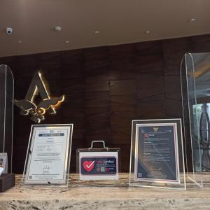 three framed signs on a counter in a room at Ayaka Suites in Jakarta