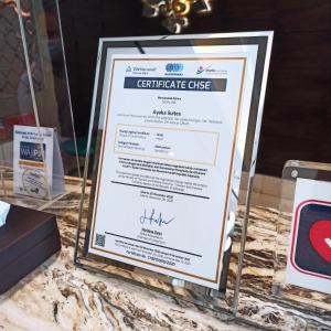 a sign for a certificate ofgraduate office on a table at Ayaka Suites in Jakarta