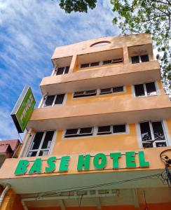 a tall building with a leasing hotel sign on it at BASE HOTEL in Kuala Kubu Bharu