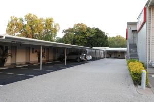 eine Gruppe von Gebäuden mit einem Parkplatz in der Unterkunft Route 66 Motor Inn in Emerald