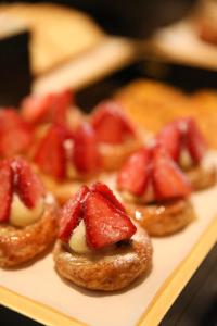 a plate with four strawberries on top of doughnuts at Hyatt Regency Wuxi in Wuxi