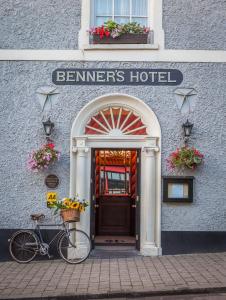 a bike parked in front of a cleaners hotel at Dingle Benners Hotel in Dingle