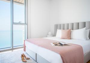 a bedroom with a bed with a book on it at Nasma Luxury Stays - Blue Waters Island in Dubai
