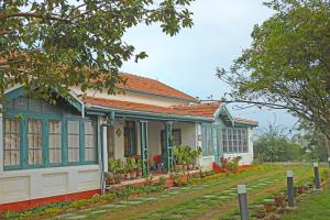 a house with a blue and white at HS Holiday Home in Coonoor