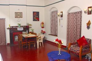 a dining room with a table and chairs at HS Holiday Home in Coonoor